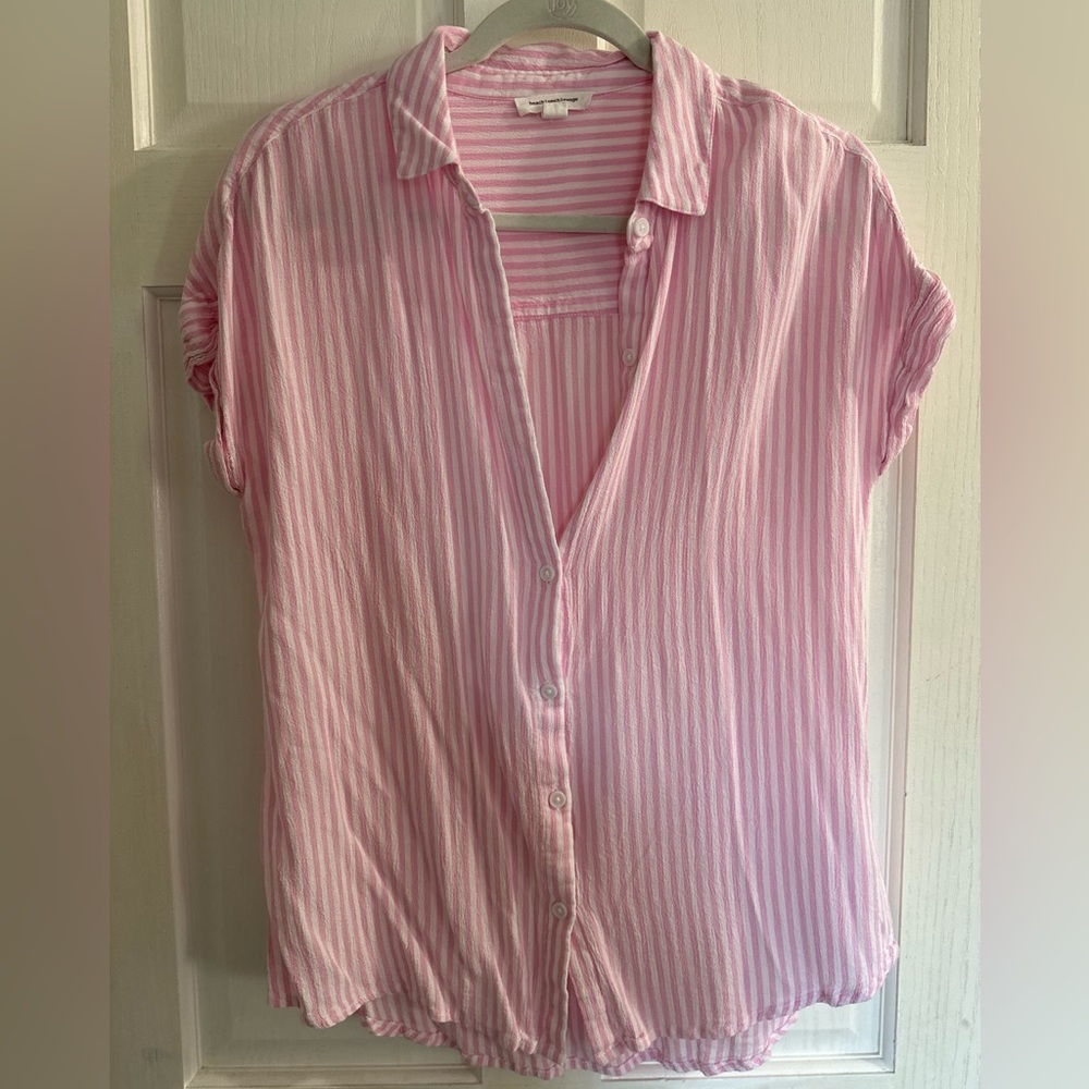 Pink striped shirt.